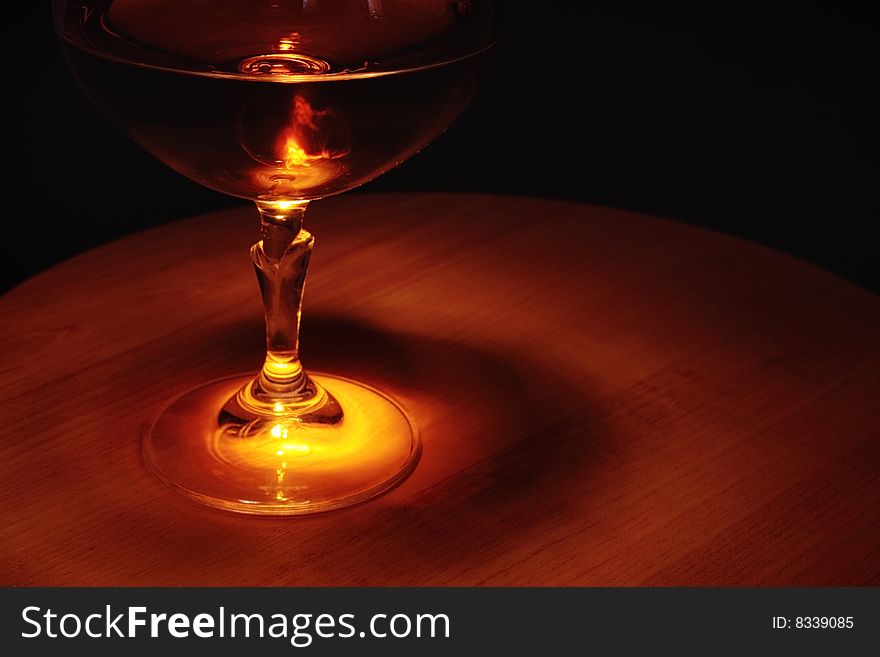 Brandy in glass on a wooden table