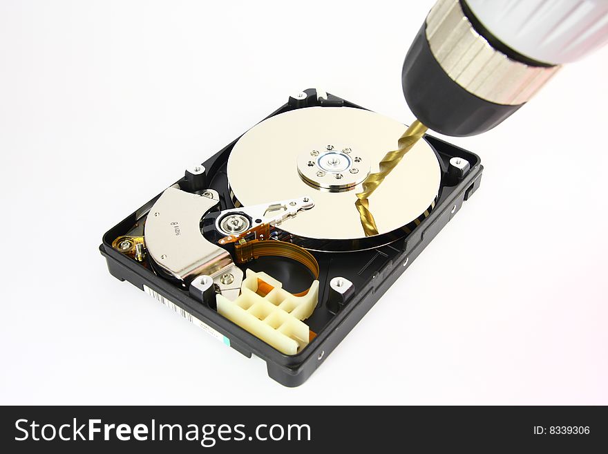 Opened Hard drive lying on the white background with drill, front view. Opened Hard drive lying on the white background with drill, front view