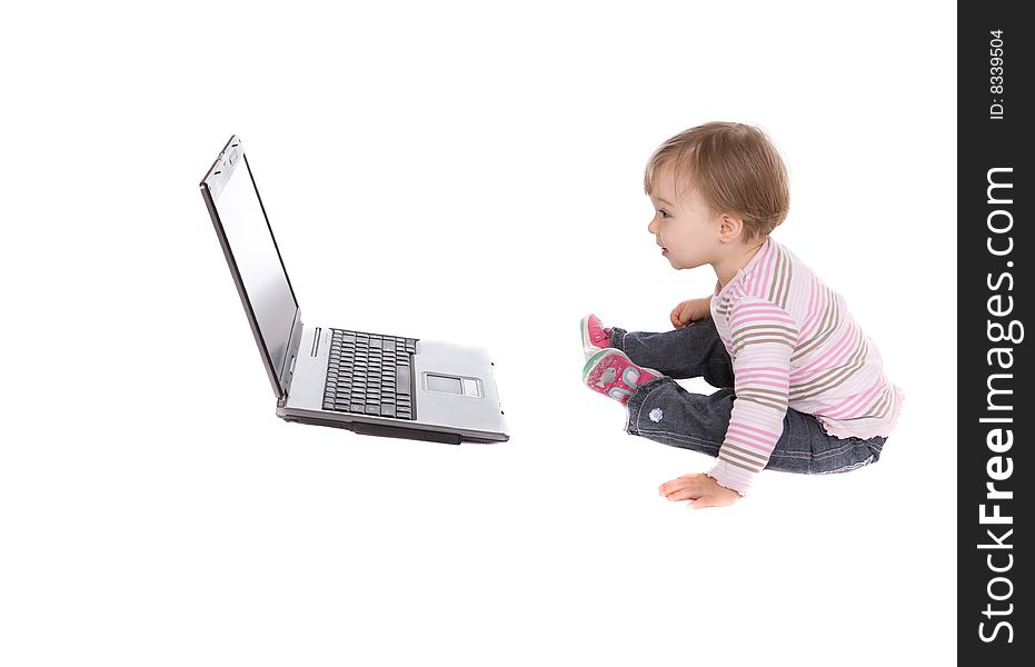 Sweet baby girl playing on laptop.over white background. Sweet baby girl playing on laptop.over white background