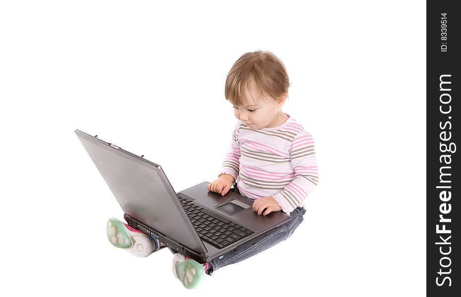 Sweet baby girl playing on laptop.over white background. Sweet baby girl playing on laptop.over white background