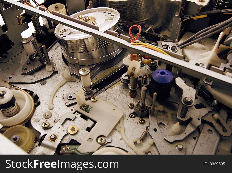 Inside old video cassette recorder. Dusty and dirty. Narrow depth of field. Inside old video cassette recorder. Dusty and dirty. Narrow depth of field.