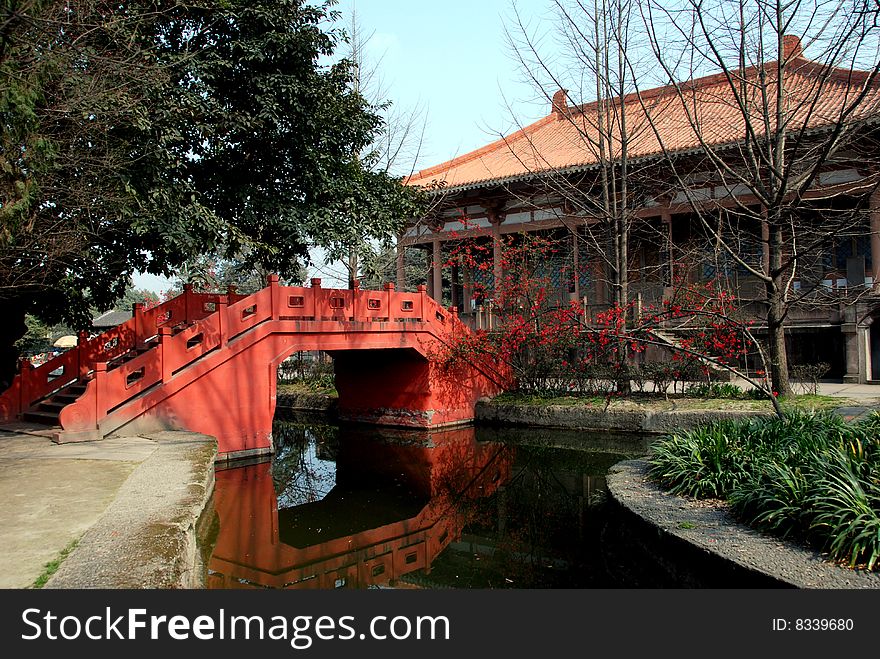 A beautiful orange Chinese bridge and the great temple prayer hall at Wang Cong Ci Park in Pixian, Sichuan Province, China (Lee Snider Photo). A beautiful orange Chinese bridge and the great temple prayer hall at Wang Cong Ci Park in Pixian, Sichuan Province, China (Lee Snider Photo)