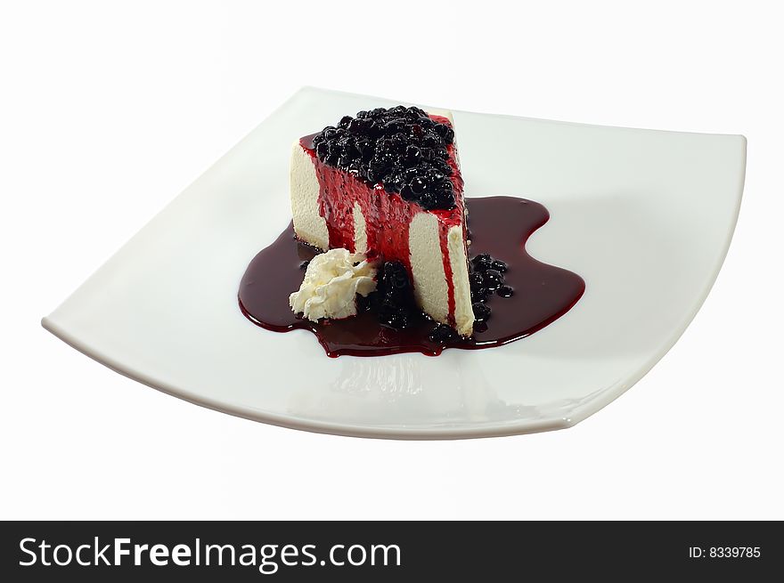 Ice-cream with a bilberry on a square dish on a white background