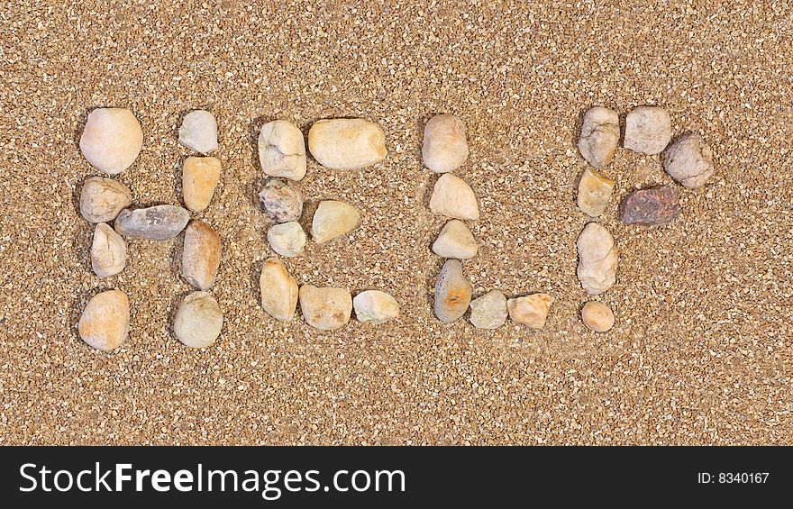 Help written in the sand using rocks. Help written in the sand using rocks