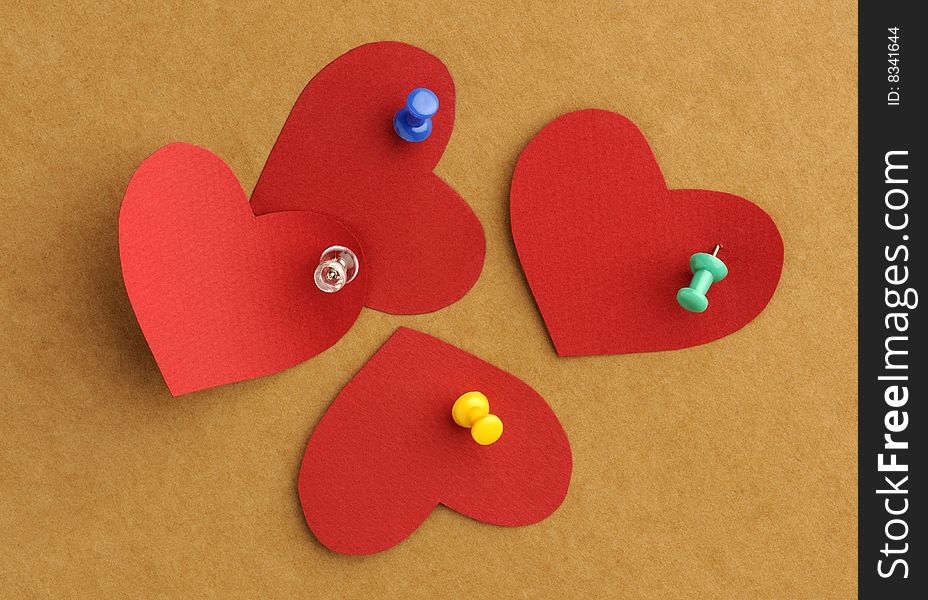 Paper s hearts with  thumbtacks