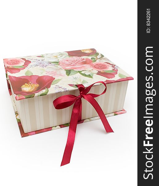 Beautiful gift  box cover with red and pink flowers tied in a red bow isolated on white background. Beautiful gift  box cover with red and pink flowers tied in a red bow isolated on white background.