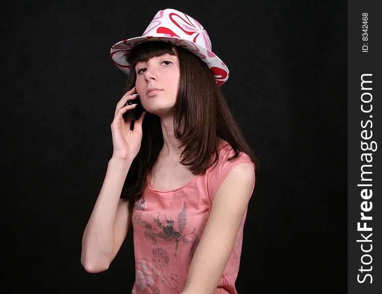 Girl talking by phone in studio