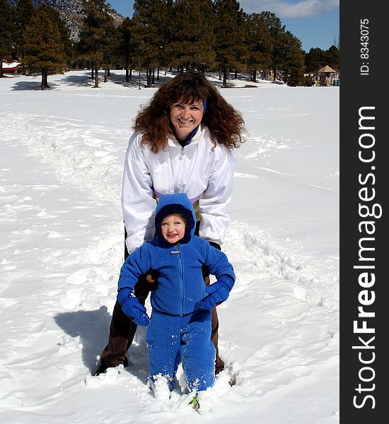 An Attractive Woman and a Little Girl in the Snow. An Attractive Woman and a Little Girl in the Snow