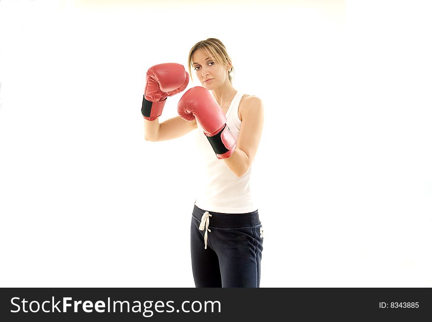 Young kickboxer woman training, isolated