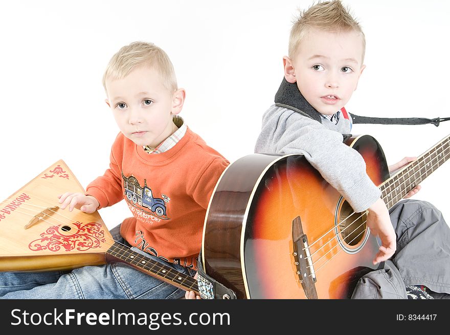 Brothers playing on stringed musical instruments. Brothers playing on stringed musical instruments