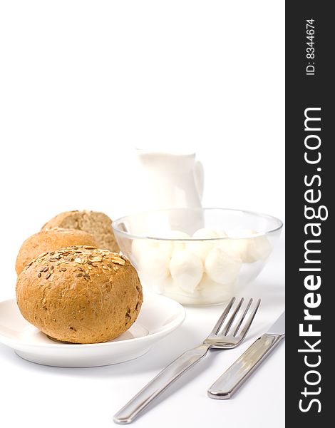 Bread, milk and mozzarella closeup on white