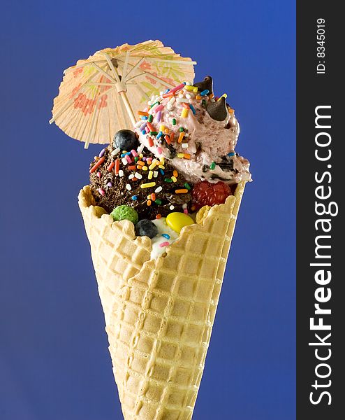 Close up shot of nice ice cream with umbrella on blue background. Close up shot of nice ice cream with umbrella on blue background