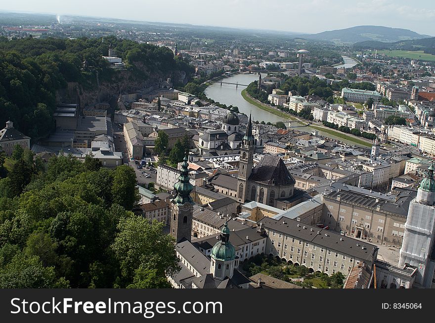 Cityscape shows Salzburg with river going across it, tilted horizon adds dynamics to the scenery. Cityscape shows Salzburg with river going across it, tilted horizon adds dynamics to the scenery