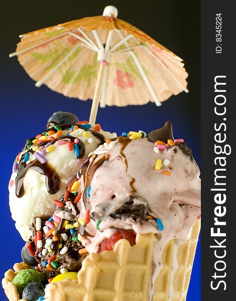 Close up shot of melting ice cream with decoration on blue and black background