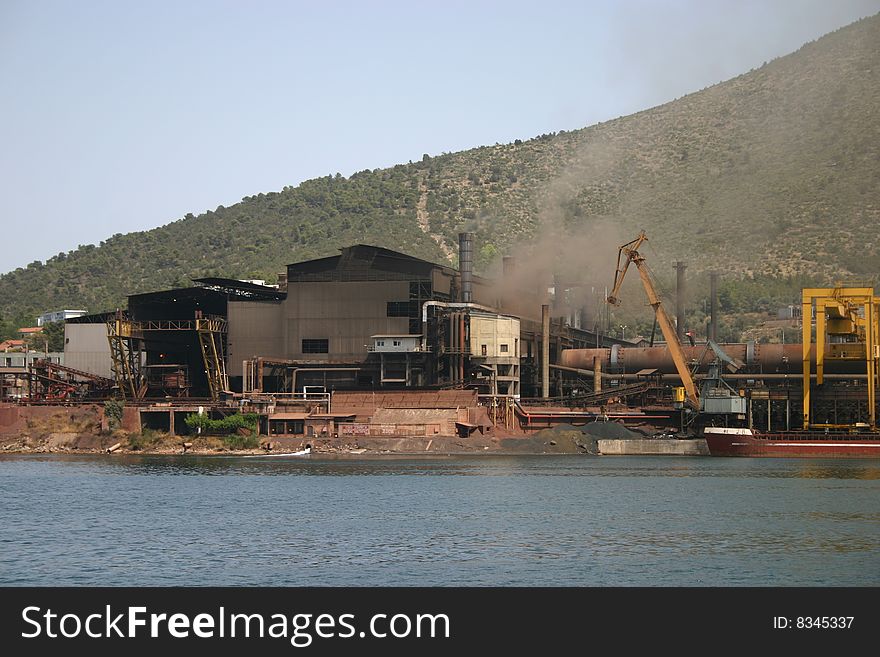 An industrial complex sitting on a lake in Greece.