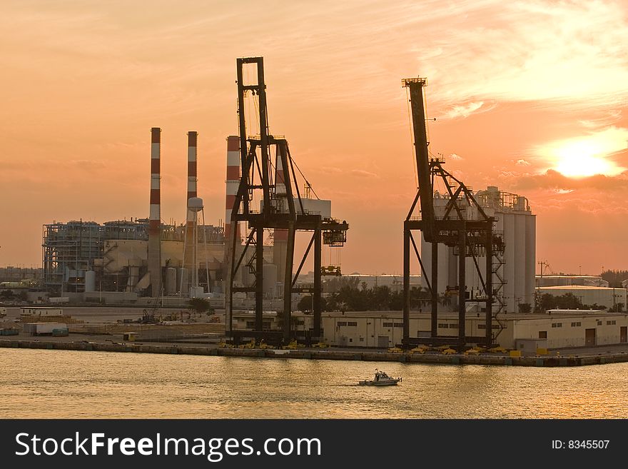 An industrial shipping area on the coast at sunrise or sunset. An industrial shipping area on the coast at sunrise or sunset