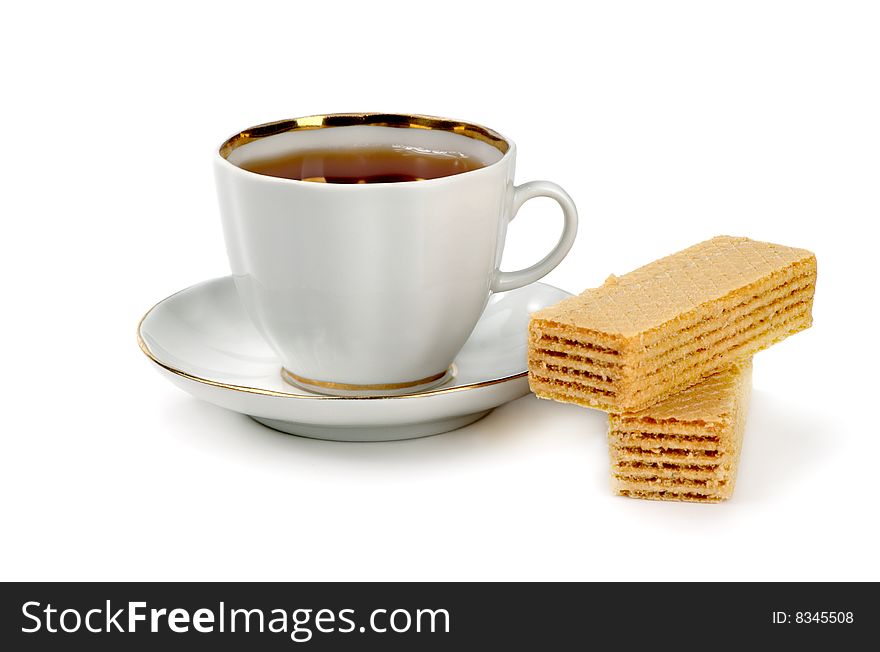 Cup of strong tea and wafer on a white background. Cup of strong tea and wafer on a white background