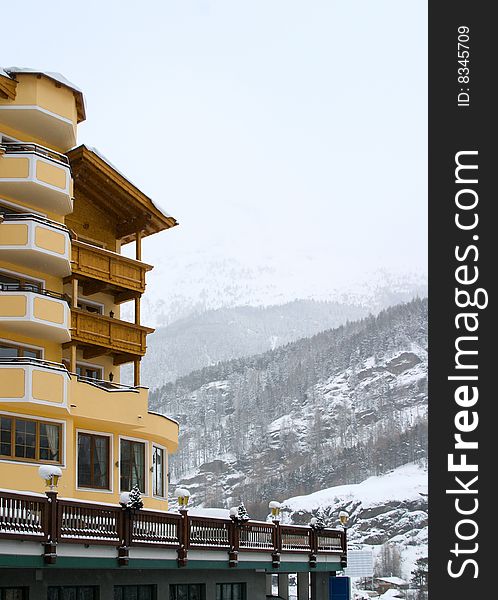 Hotel in Alps, mountain in fog at background
