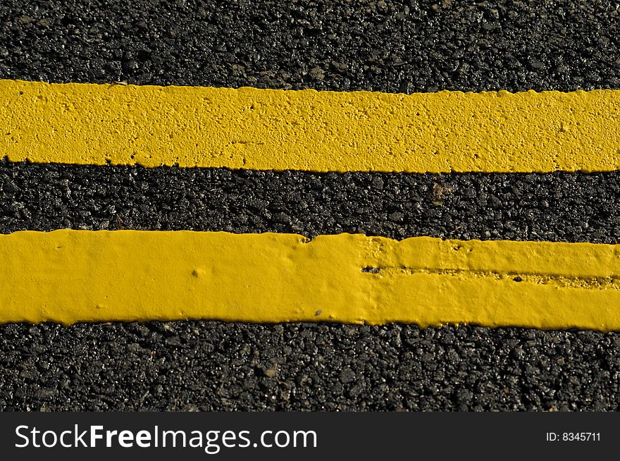 Close up of double yellow lines on the tarmac
