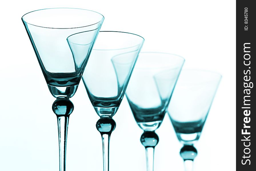Four blue wineglasses against the white background. Four blue wineglasses against the white background
