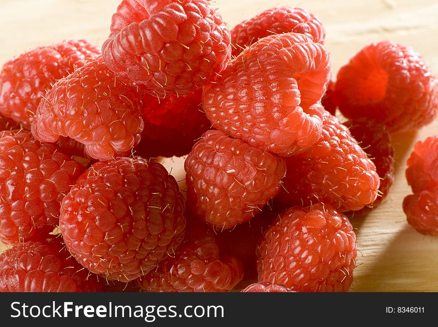 Heap of a lot of fresh raspberries on white background