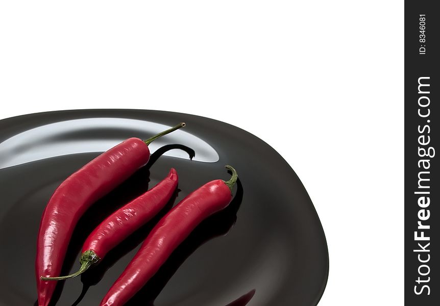 Red chili pepper on the plate isolated