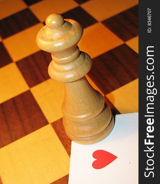 Queen of hearts symbolised with chess piece and playing card.