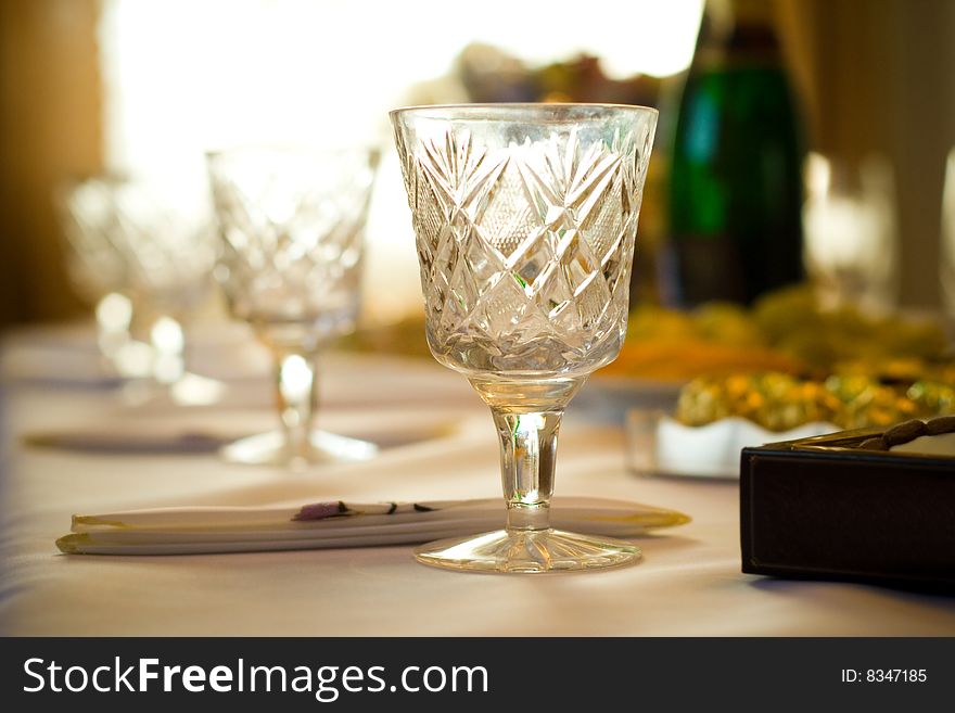 Glasses, napkins, sweets on a white cloth