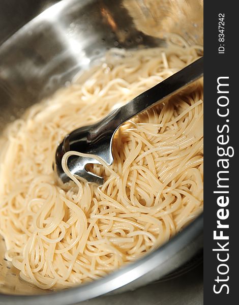 Spaghetti pasta on a stainless pot. Spaghetti pasta on a stainless pot