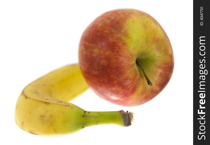 Apple and banana isolated on white. Shallow DOF.