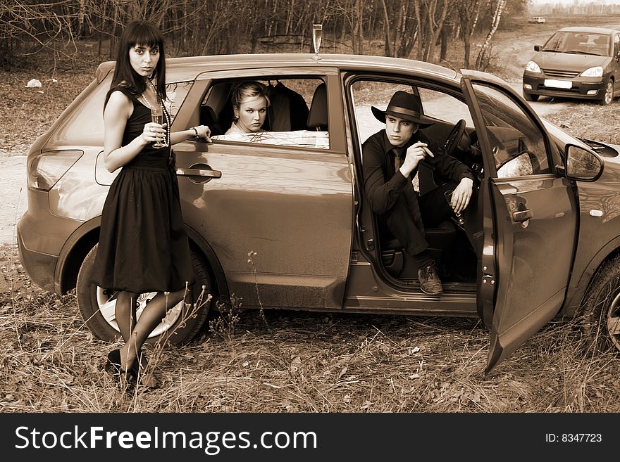 Brunette , man and woman with cigar, wine in car. Brunette , man and woman with cigar, wine in car