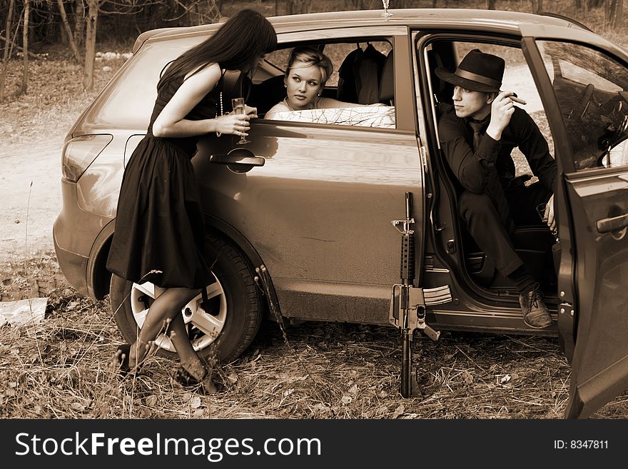 Brunette , man and woman with cigar, wine in car. Brunette , man and woman with cigar, wine in car