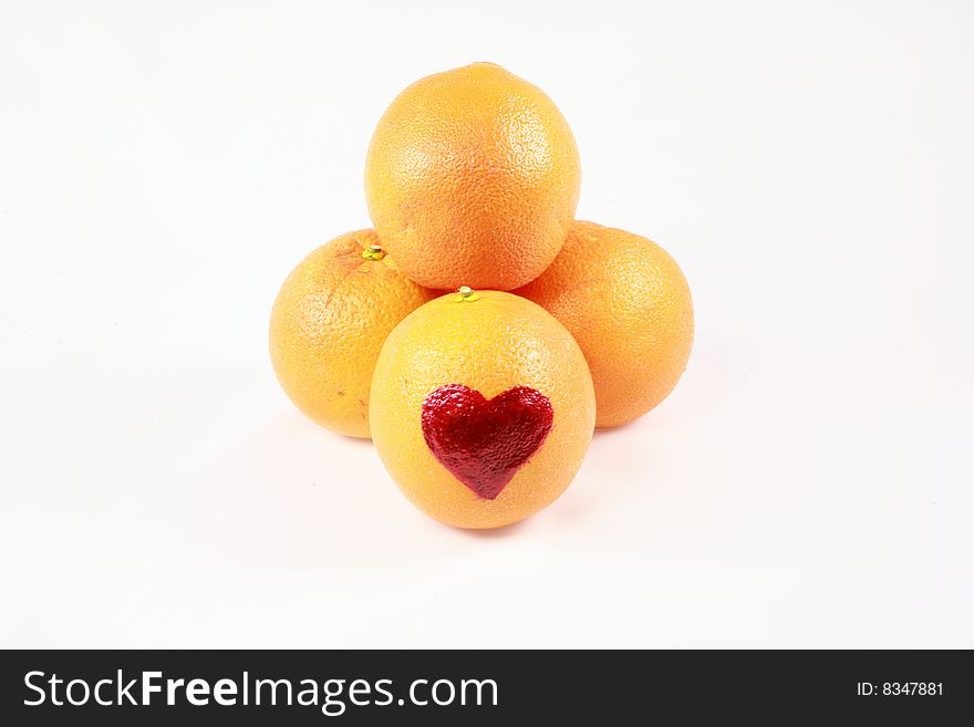 An array of oranges with a heart on one. An array of oranges with a heart on one