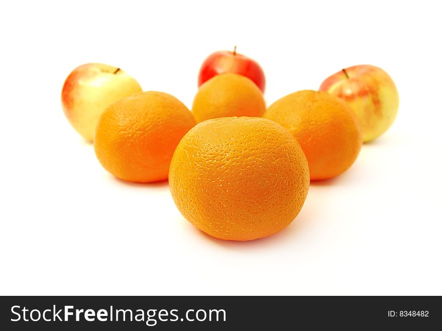 Four mandarines and three apples on a white background
