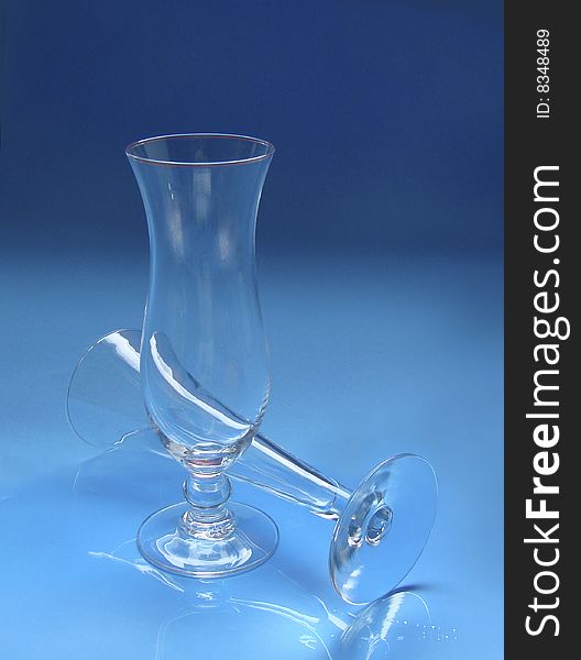 Two glasses on blue with reflection