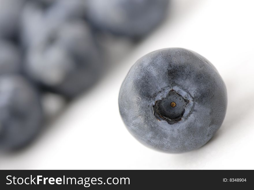 Extreme macro photo of a single blueberry with blurry blueberries far in the background. Extreme macro photo of a single blueberry with blurry blueberries far in the background.