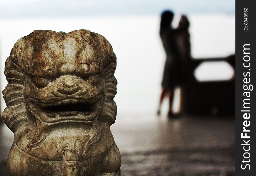 I shot this picture near the west lake in Hangzhou, the stone lion sit near the lake with a girl's shadow backgroud. I shot this picture near the west lake in Hangzhou, the stone lion sit near the lake with a girl's shadow backgroud