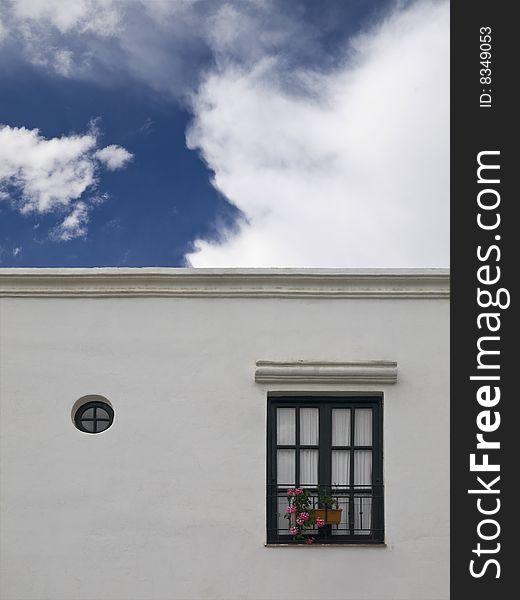 Facade of a white simple mediterranean house. Facade of a white simple mediterranean house.