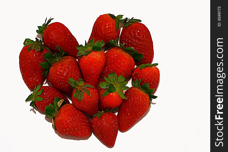 Symbol heart made of strawberry on a white background