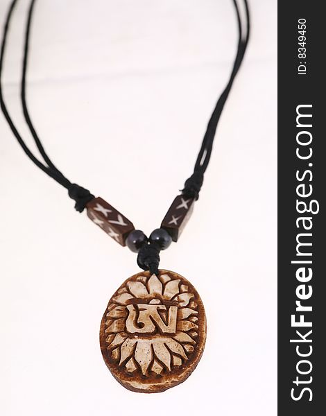 Beads of wooden made necklace with self-standing display on white background