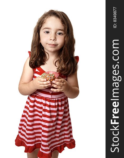 Young child holding a pink iced doughnet.   She is wearing a pink and red striped dress with little pink  heart buttons. Young child holding a pink iced doughnet.   She is wearing a pink and red striped dress with little pink  heart buttons.