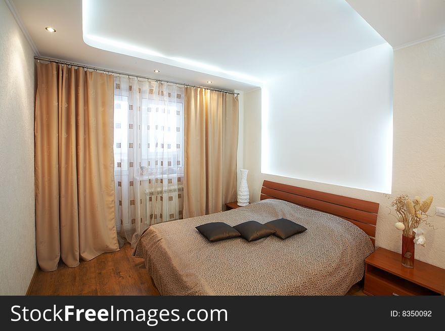 The image of a bedroom with original execution of a ceiling. The image of a bedroom with original execution of a ceiling