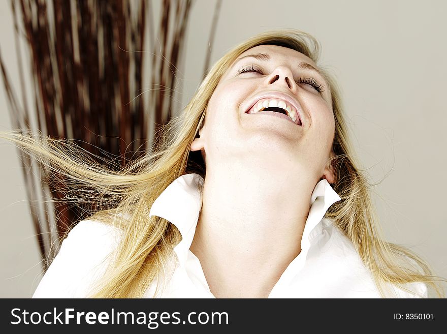 Young blond model smiling with head layed back