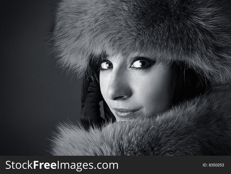 Portrait of young beautiful brunette on a darck background