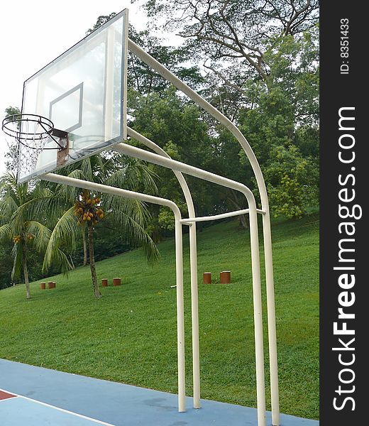 Basketball Frame With Trees And Grass Behind