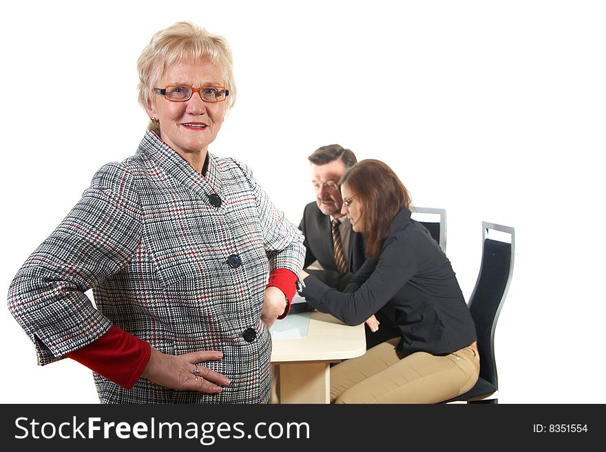 Businesswoman in office environment. Three people with focus on young woman in front. Isolated over white. Businesswoman in office environment. Three people with focus on young woman in front. Isolated over white.