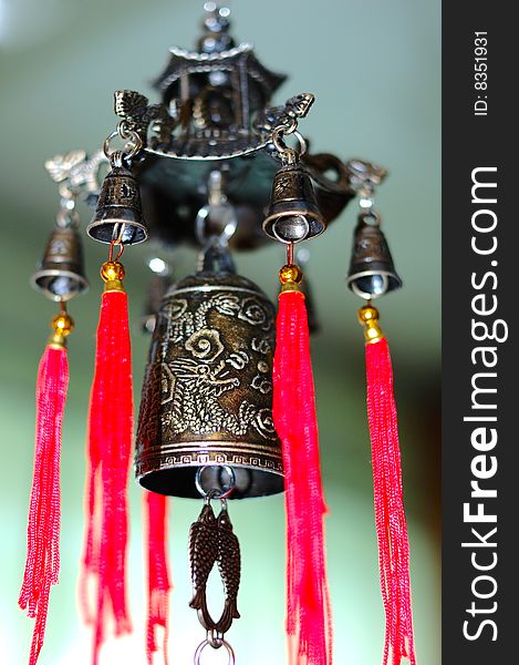 Old chinese bronze bell with dragons and hieroglyphs - on defocused (blurred) background. Old chinese bronze bell with dragons and hieroglyphs - on defocused (blurred) background.