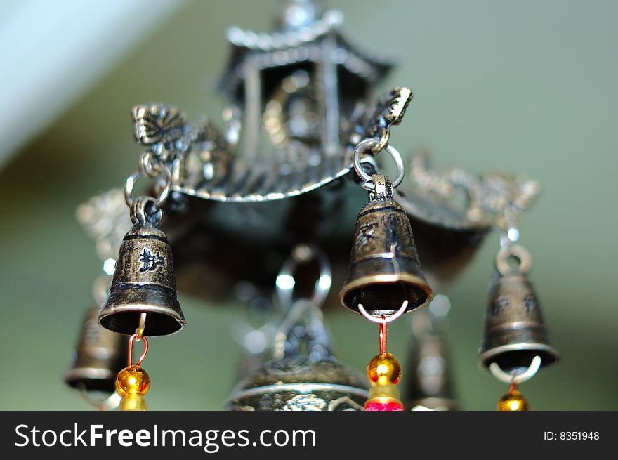 Old chinese bronze bell with dragons and hieroglyphs - on defocused (blurred) background. Old chinese bronze bell with dragons and hieroglyphs - on defocused (blurred) background.