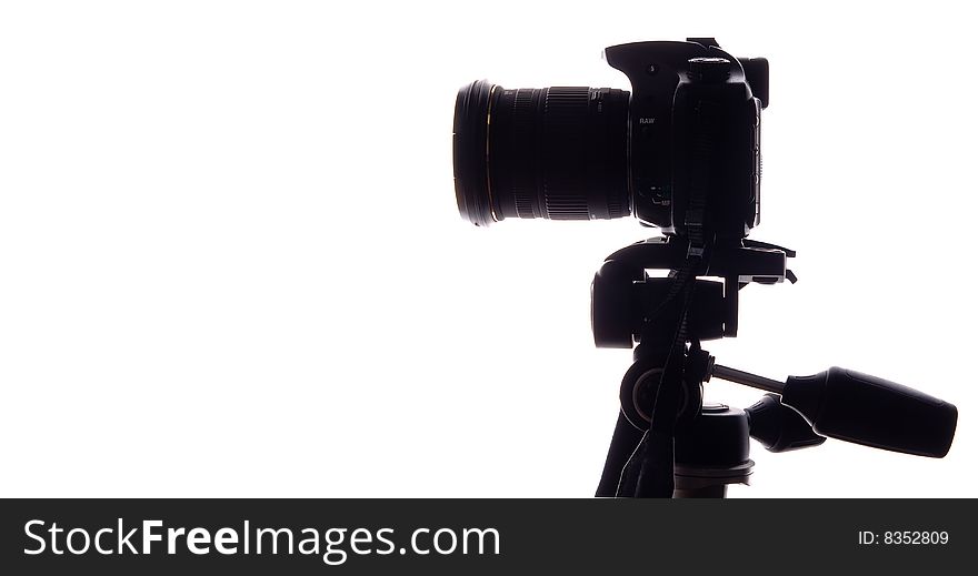 Professional digital camera with zoom lens on tripod, Isolated white background, contour
