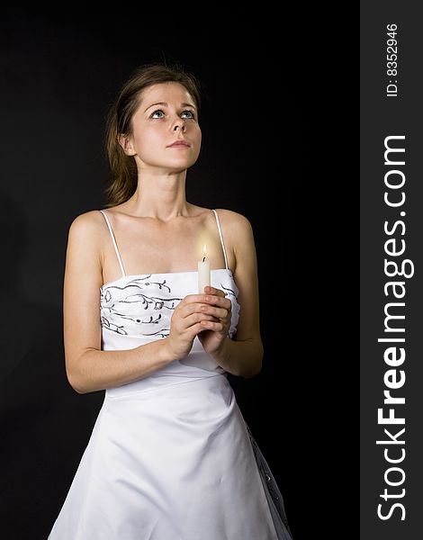 Woman dreams with a candle in hands